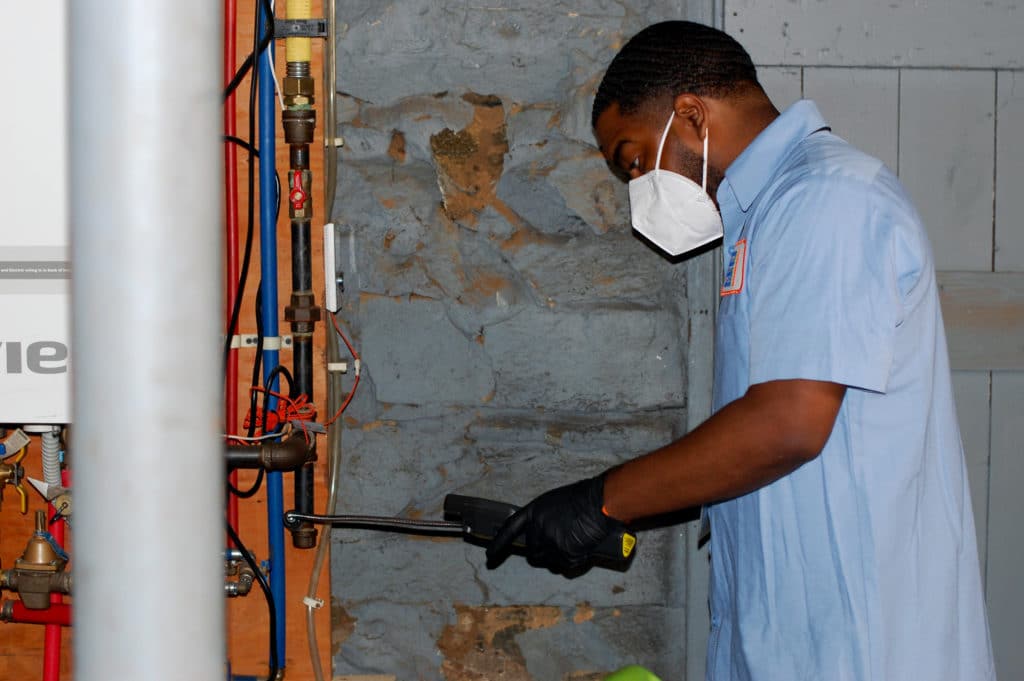 HCP specialist insulating a stone foundation wall