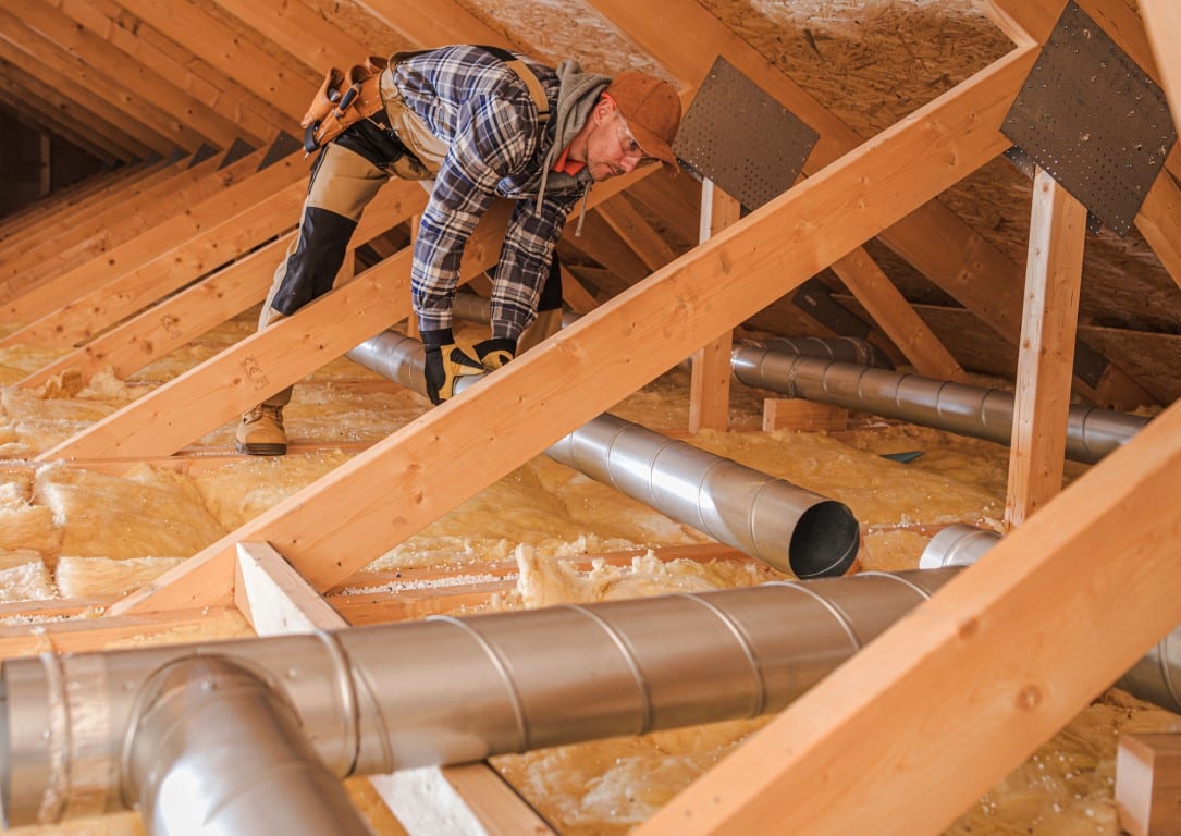 Air quality specialist installing residential air filtration