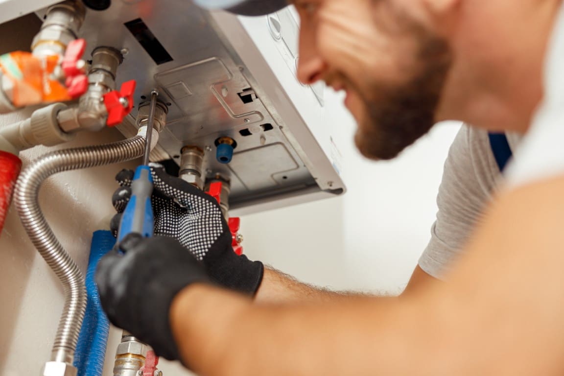 hvac-medium-closeup-of-plumber-using-screwdriver-while-install-2022-03-09-03-07-35-utc-Medium.jpg