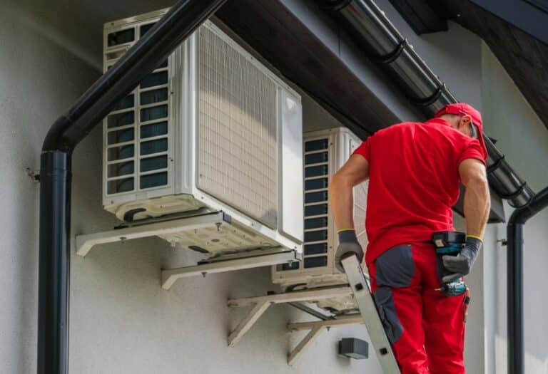 Caucasian Heating and Cooling Technician Performing Scheduled Heat Pump and Air Condition Units Maintenance