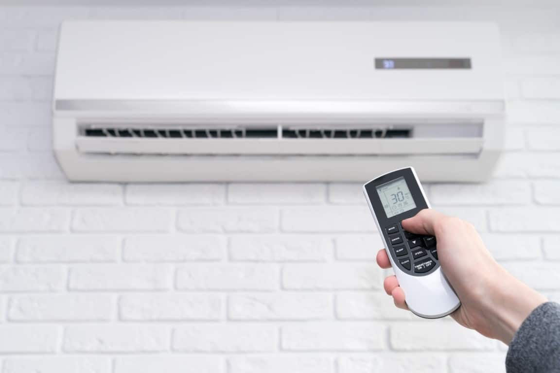 hvac-medium-home-air-conditioner-and-hand-with-remote-control-2022-11-15-02-45-35-utc-Medium.jpg