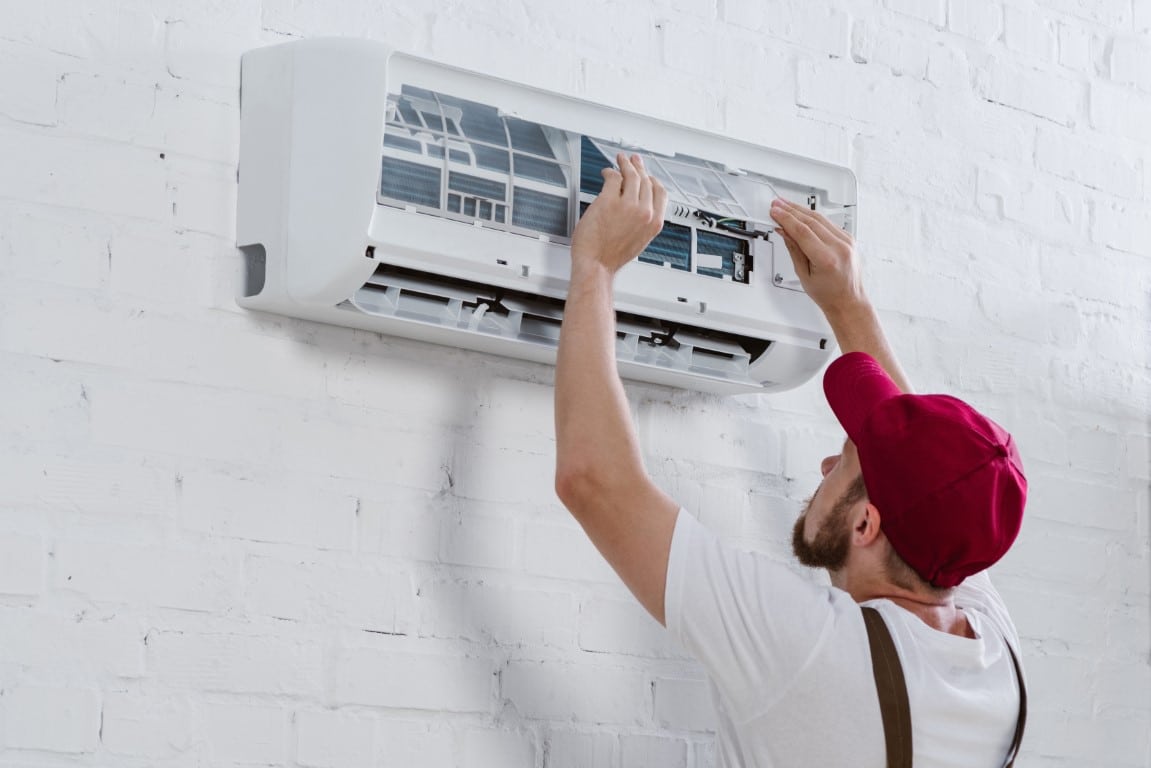 hvac-medium-young-repairman-changing-filter-for-air-conditione-2022-12-16-19-15-17-utc-Medium.jpg