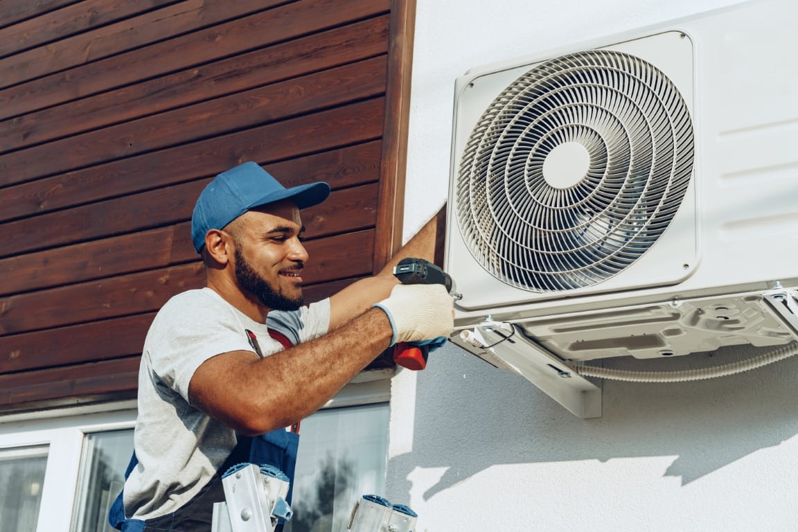 hvac-repairman-in-uniform-installing-the-outside-unit-o-2021-09-03-16-17-09-utc-Medium.jpg
