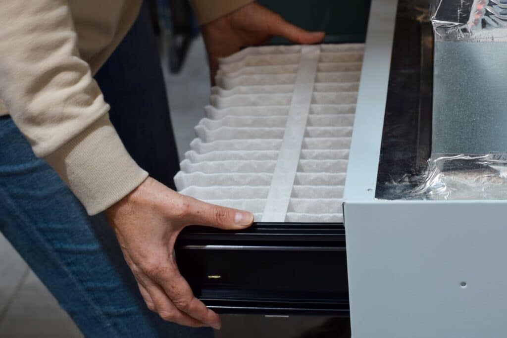 HVAC technician cleaning system components