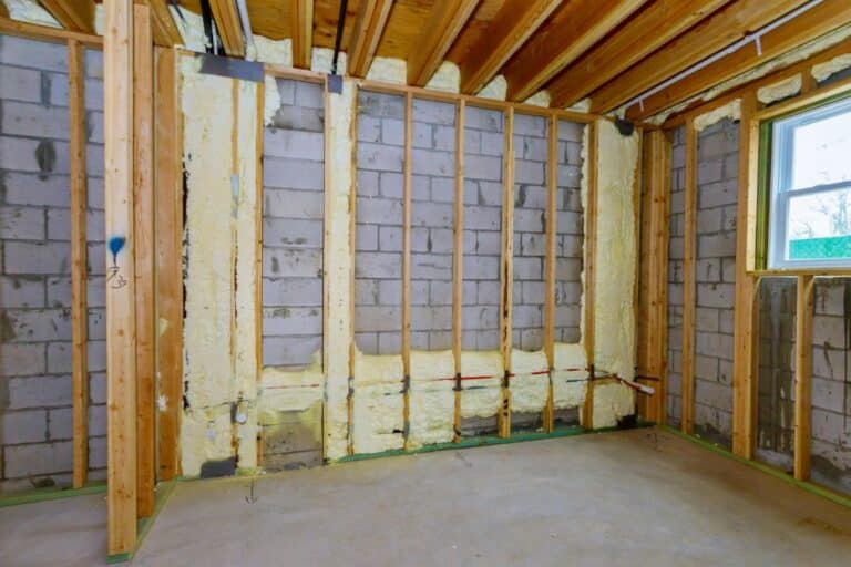 New wooden house in foam for insulation the wall of a basement unfinished under construction