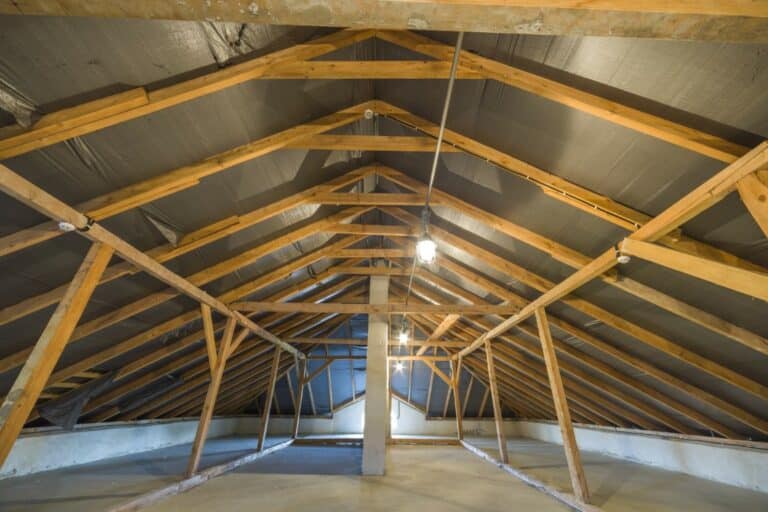 Attic of a building with wooden beams of a roof structure.