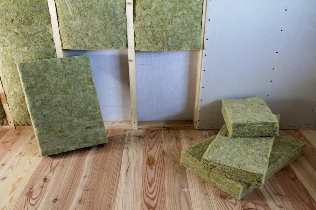 Wooden frame for future walls with drywall plates insulated with rock wool and fiberglass insulation staff for cold barrier. Comfortable warm home, economy, construction and renovation concept.